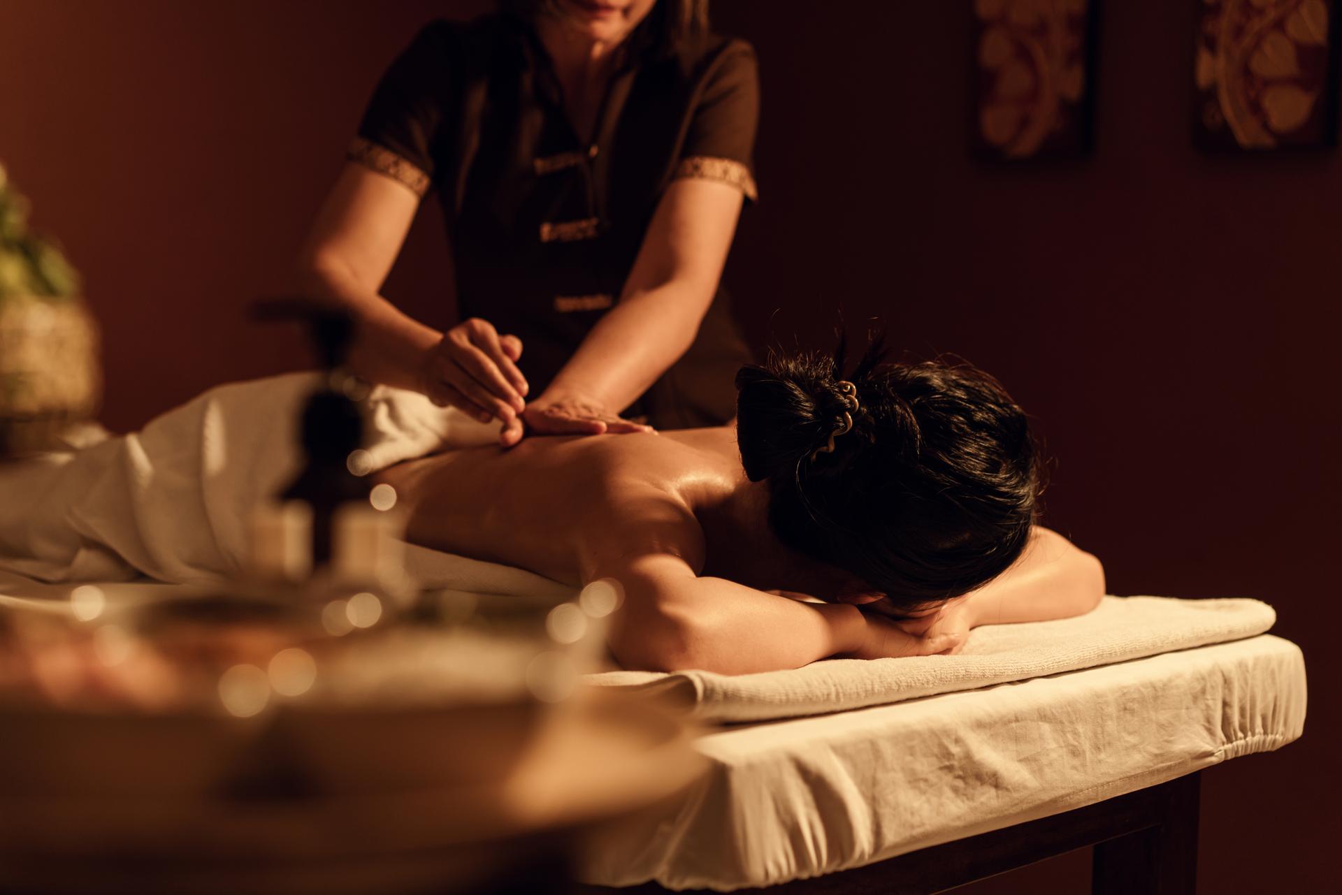 Relaxation woman back massage with masseur in cosmetology spa centre.